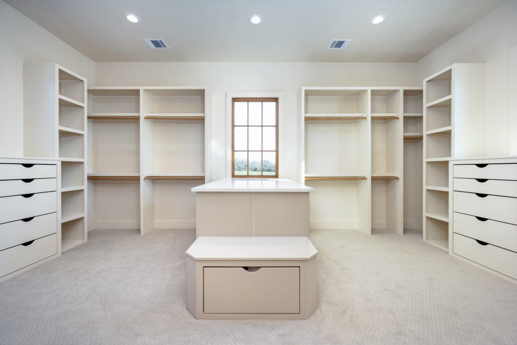 Walk-in closet with center island and built-in shelves