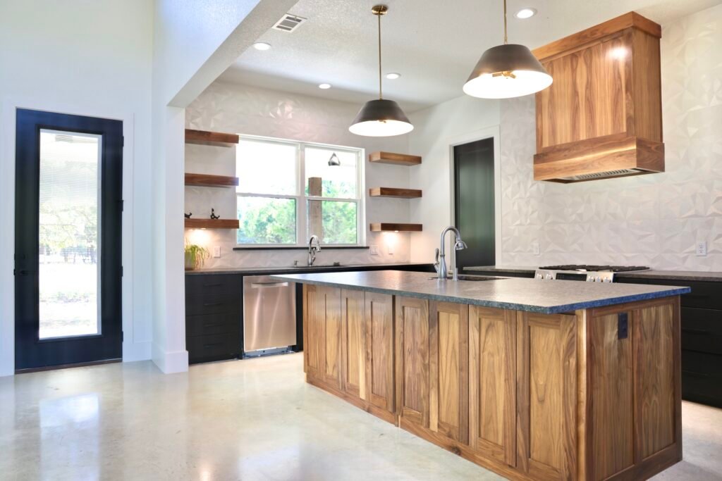 Modern kitchen with wood island and pendant lights