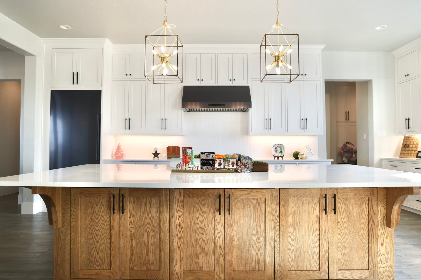 White kitchen with island and pendant lights