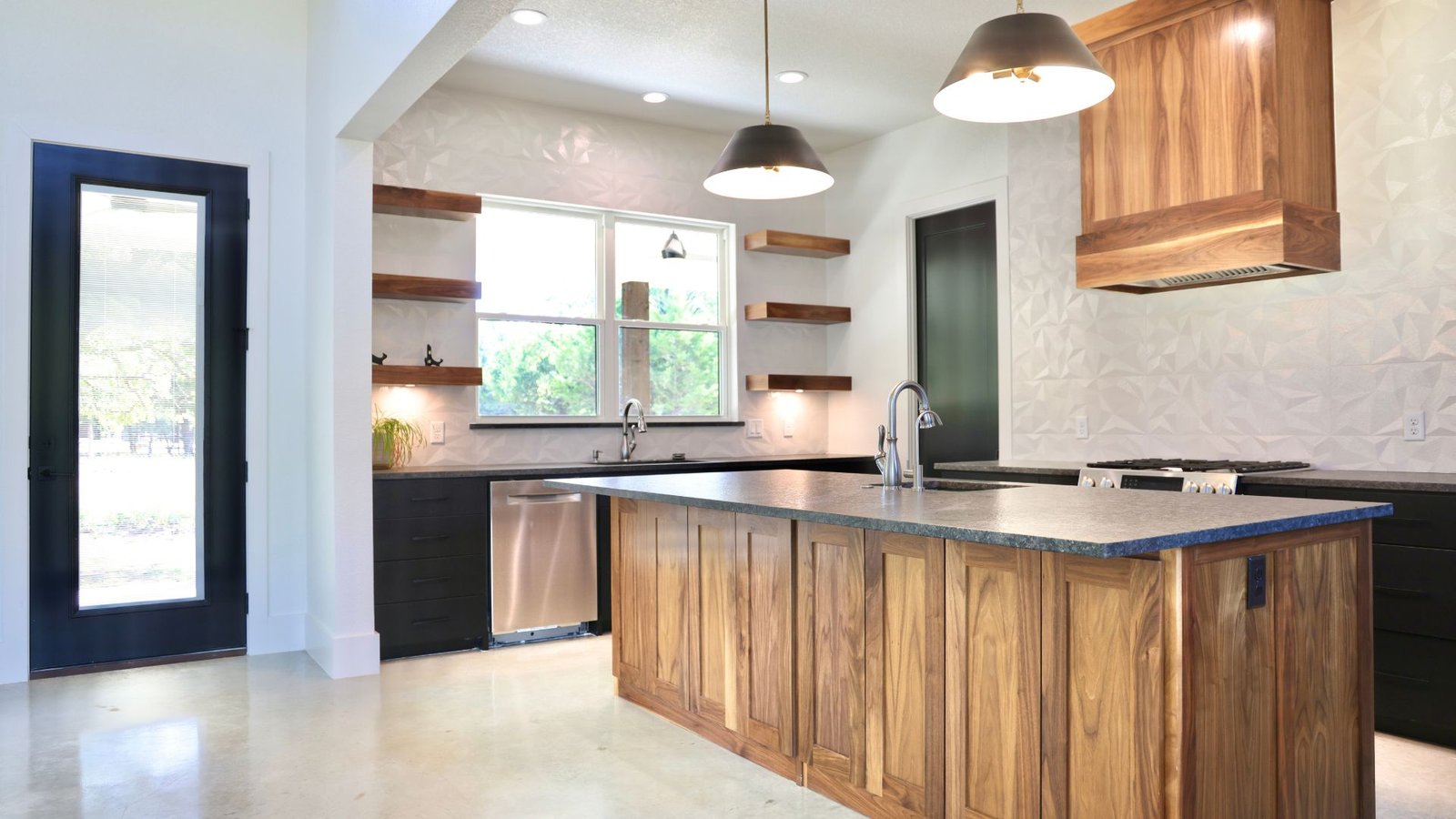 Bright kitchen with wood island and pendant lights
