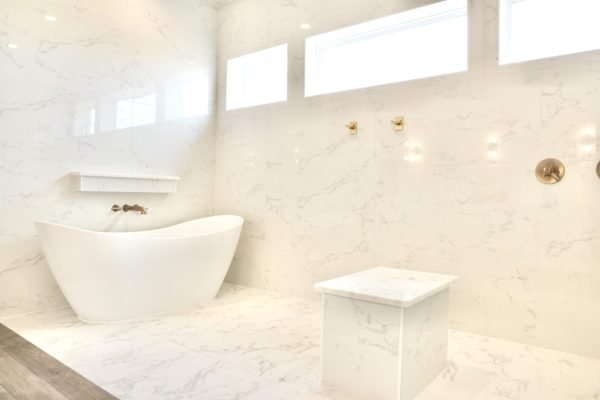Modern white shower with bench and skylight windows